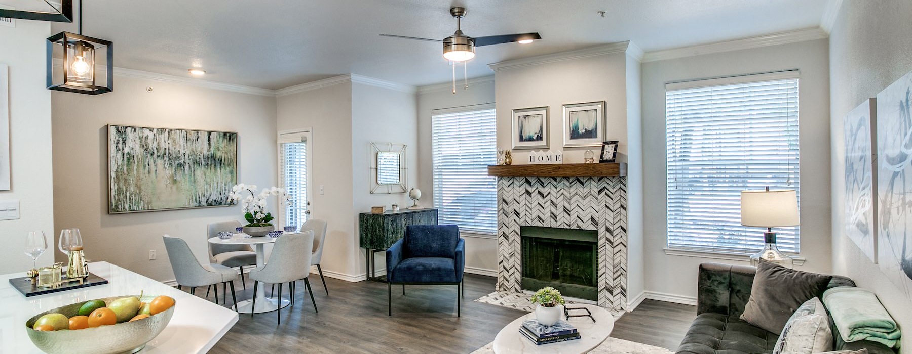 Generous living spaces with beautiful natural lighting a living room with a fireplace, a couch and chairs