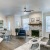 a living room with a fireplace, a couch and chairs